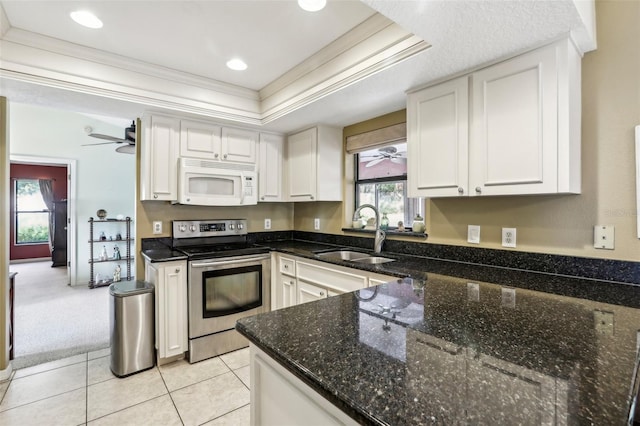 kitchen featuring sink, stainless steel electric range, crown molding, white cabinetry, and dark stone countertops