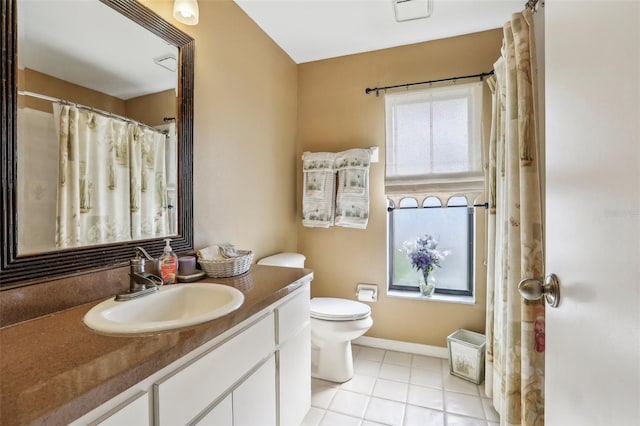 bathroom featuring vanity, tile patterned floors, and toilet