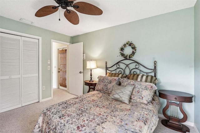 carpeted bedroom with ceiling fan and a closet