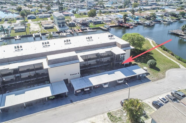 birds eye view of property featuring a residential view and a water view