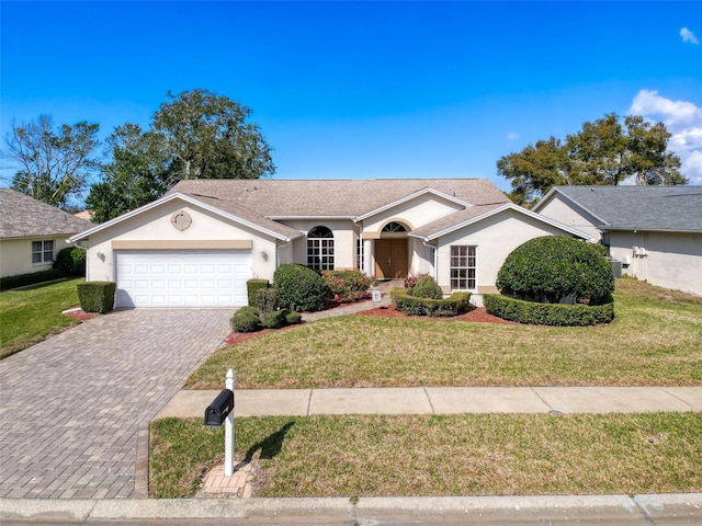 8447 Pavilion Dr, Hudson, FL 34667 - single story home featuring stucco siding, an attached garage, a front yard, and decorative driveway