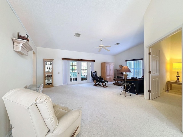 8447 Pavilion Dr, Hudson, FL 34667 - living area with carpet floors, french doors, lofted ceiling, visible vents, and ceiling fan