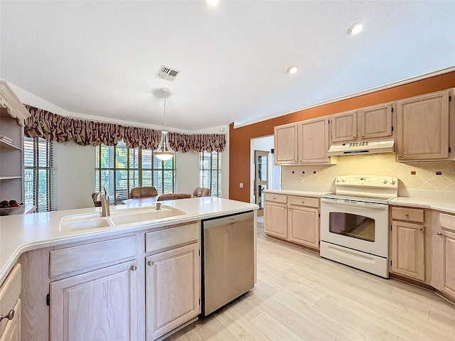 8447 Pavilion Dr, Hudson, FL 34667 - kitchen featuring light countertops, a sink, white range with electric cooktop, stainless steel dishwasher, and under cabinet range hood