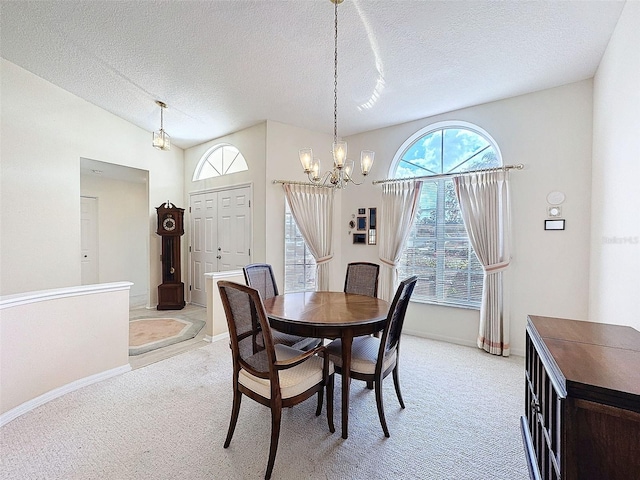 8447 Pavilion Dr, Hudson, FL 34667 - dining room featuring a textured ceiling, baseboards, light carpet, lofted ceiling, and a notable chandelier