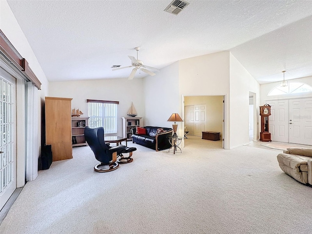 8447 Pavilion Dr, Hudson, FL 34667 - living room with vaulted ceiling, a ceiling fan, a textured ceiling, visible vents, and carpet