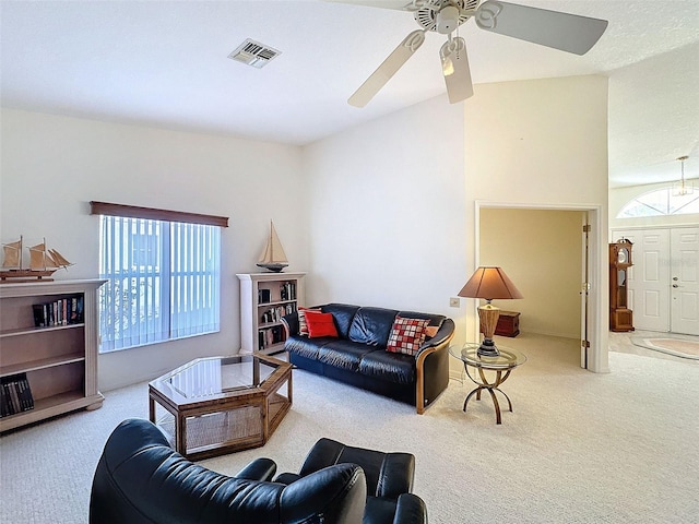 8447 Pavilion Dr, Hudson, FL 34667 - carpeted living room with lofted ceiling, ceiling fan, and visible vents