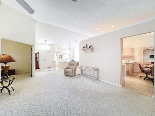 8447 Pavilion Dr, Hudson, FL 34667 - sitting room featuring vaulted ceiling, light carpet, a textured ceiling, baseboards, and ceiling fan