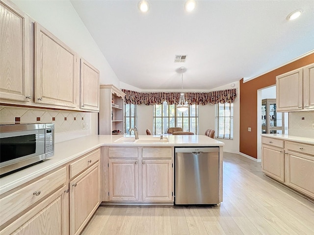 8447 Pavilion Dr, Hudson, FL 34667 - kitchen with light countertops, a sink, appliances with stainless steel finishes, a peninsula, and visible vents