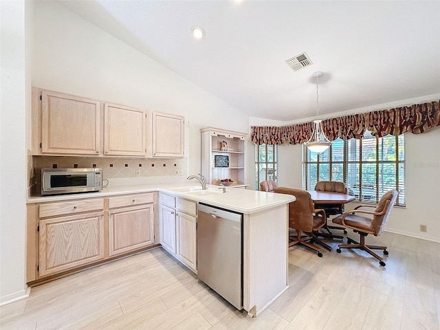 8447 Pavilion Dr, Hudson, FL 34667 - kitchen featuring light countertops, a sink, appliances with stainless steel finishes, lofted ceiling, and visible vents