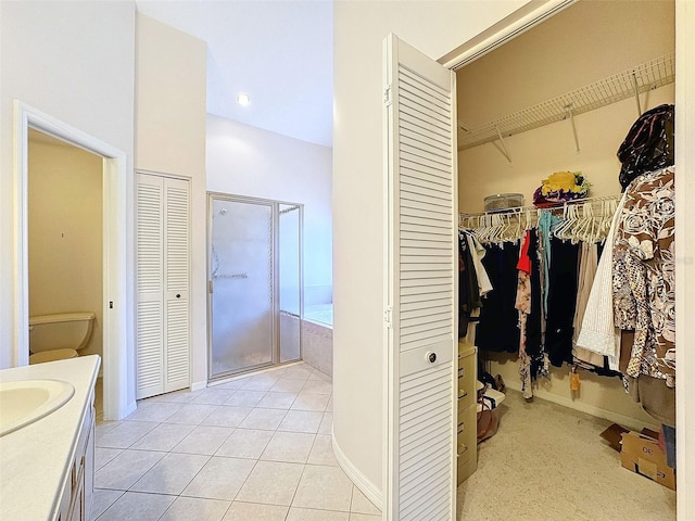 8447 Pavilion Dr, Hudson, FL 34667 - bathroom featuring a closet, toilet, vanity, a shower stall, and tile patterned flooring