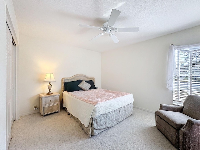 8447 Pavilion Dr, Hudson, FL 34667 - bedroom with baseboards, ceiling fan, carpet floors, and a textured ceiling
