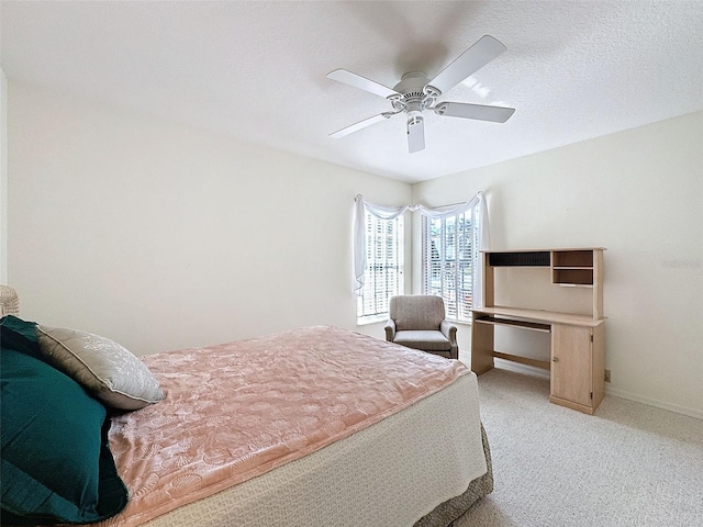 8447 Pavilion Dr, Hudson, FL 34667 - bedroom featuring light carpet, baseboards, ceiling fan, and a textured ceiling