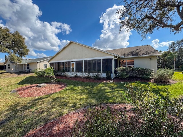8447 Pavilion Dr, Hudson, FL 34667 - rear view of property featuring a sunroom, stucco siding, and a yard