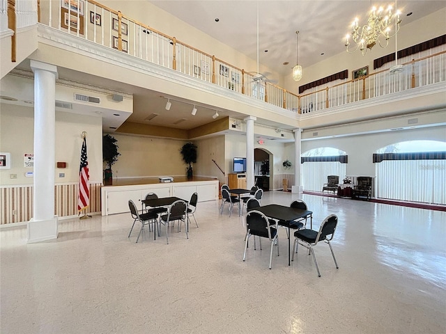 8447 Pavilion Dr, Hudson, FL 34667 - dining space with decorative columns, a towering ceiling, speckled floor, and visible vents