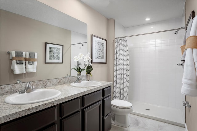 bathroom with tile patterned flooring, vanity, curtained shower, and toilet