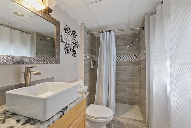 bathroom featuring vanity, curtained shower, and toilet