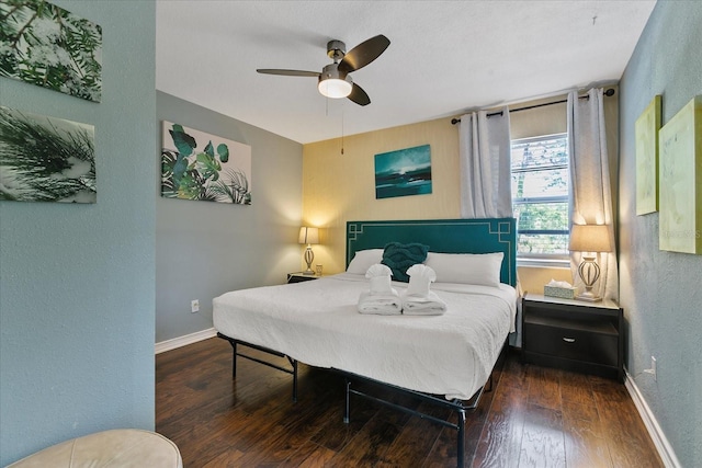 bedroom featuring ceiling fan and dark hardwood / wood-style flooring