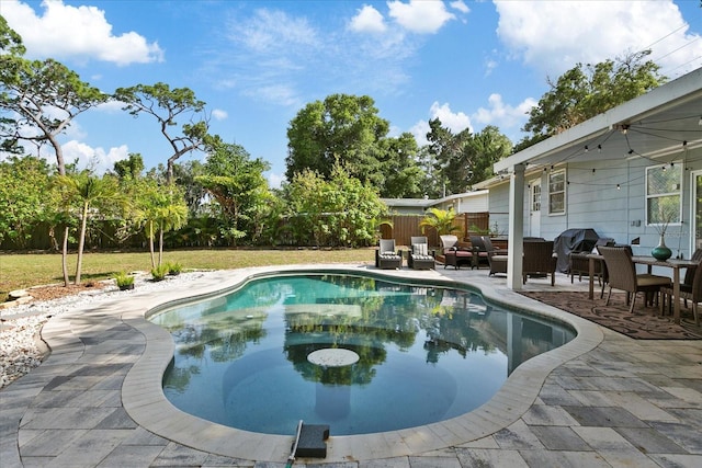 1101 N Betty Ln, Clearwater, FL 33755 - swimming pool with a patio area, a fenced backyard, an outdoor living space, and area for grilling