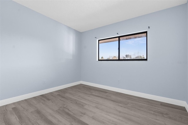 unfurnished room with light wood-type flooring