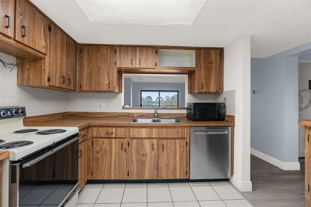 kitchen with sink, stainless steel dishwasher, electric range, and backsplash