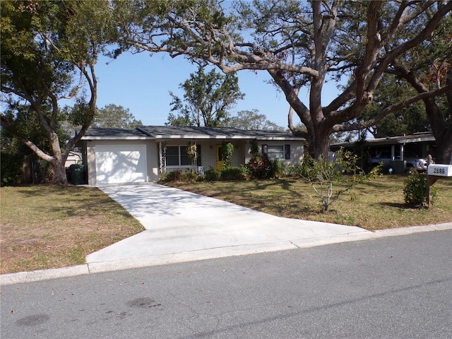 single story home with a garage and a front lawn