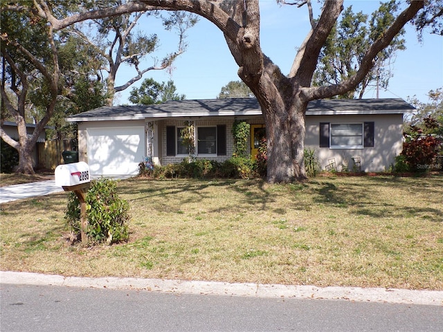 single story home featuring a garage and a front lawn