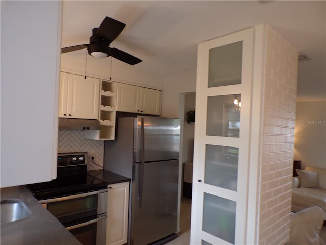 kitchen featuring white cabinetry, decorative backsplash, ceiling fan, and appliances with stainless steel finishes