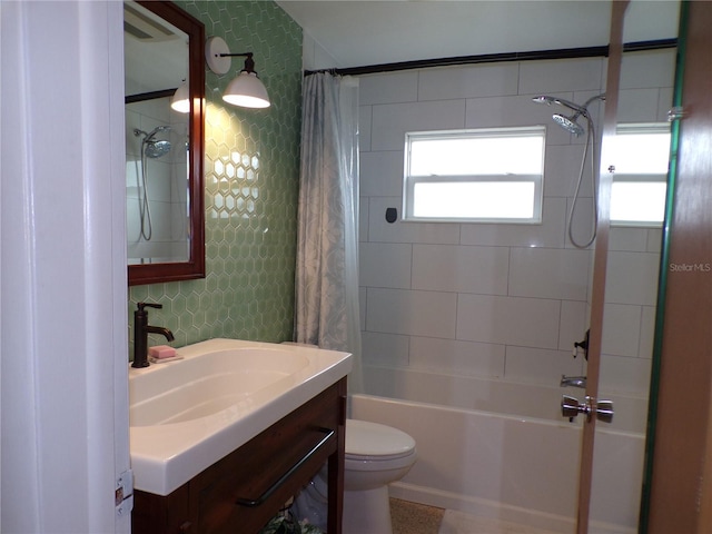 full bathroom featuring vanity, shower / bath combo, and toilet