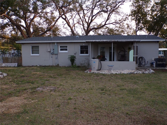 rear view of property featuring a yard