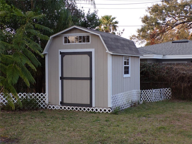 view of outdoor structure featuring a lawn