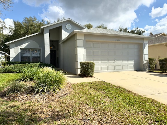 view of front of house featuring stucco siding, driveway, and an attached garage