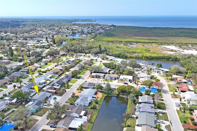 drone / aerial view with a water view and a residential view