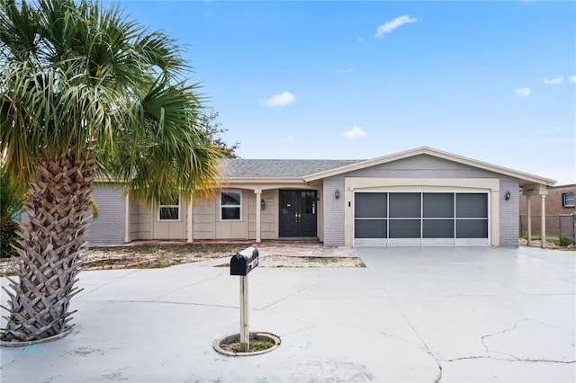 ranch-style home with a garage, driveway, and brick siding