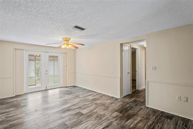 unfurnished room with dark wood-style floors, french doors, visible vents, a ceiling fan, and a textured ceiling