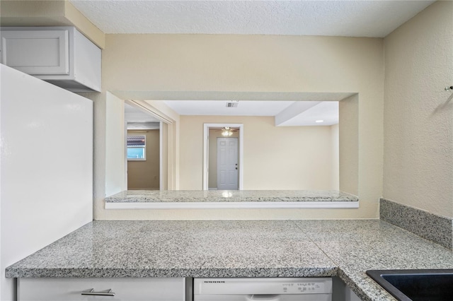 corridor featuring a textured ceiling and visible vents