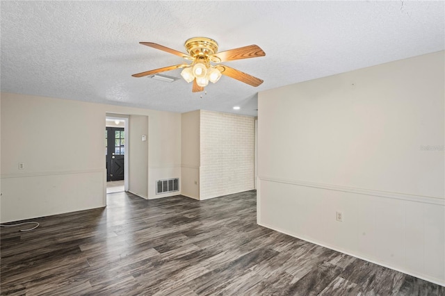 unfurnished room featuring dark wood-style floors, ceiling fan, visible vents, and a textured ceiling