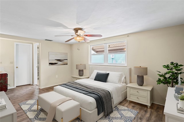 bedroom with dark wood-style floors, baseboards, visible vents, and a ceiling fan