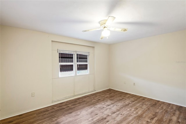 spare room with ceiling fan and wood finished floors