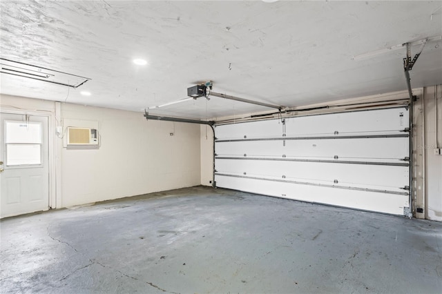garage featuring concrete block wall and a wall mounted AC