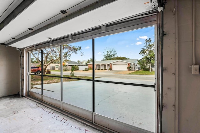 doorway with concrete flooring and a residential view