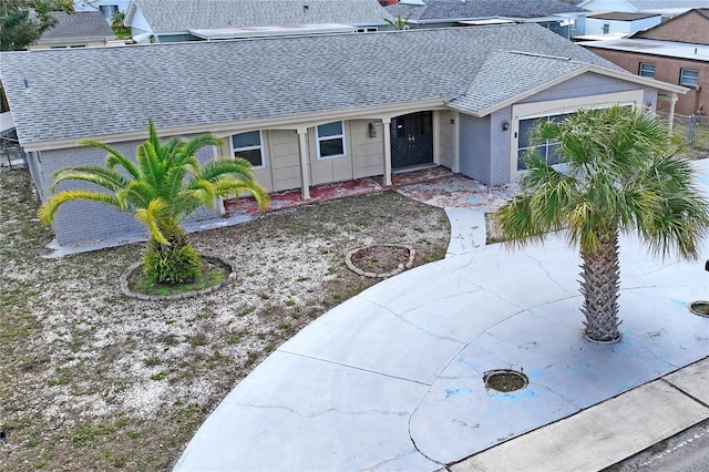 ranch-style house with roof with shingles