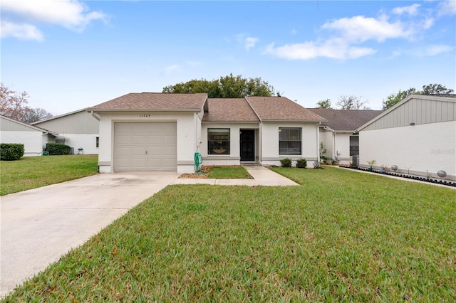 ranch-style home featuring driveway, an attached garage, a front lawn, and stucco siding