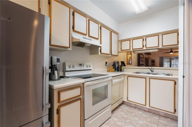 kitchen with light tile patterned floors, light countertops, a sink, white appliances, and under cabinet range hood