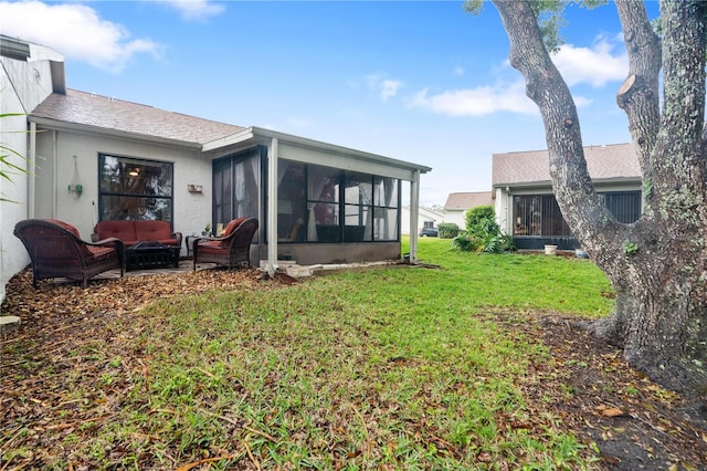 rear view of property with a sunroom, a yard, and an outdoor hangout area