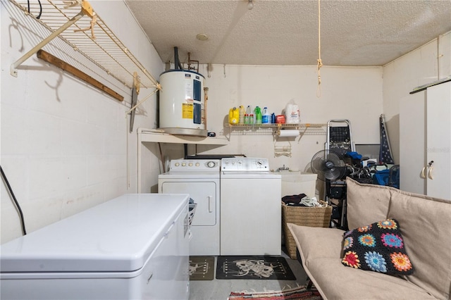 laundry room with concrete block wall, water heater, separate washer and dryer, and a textured ceiling