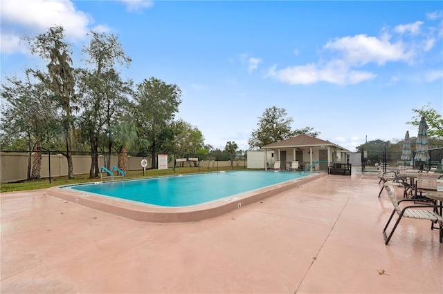 pool with fence and a patio