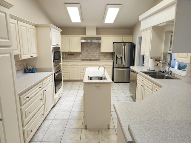 kitchen with backsplash, a center island with sink, appliances with stainless steel finishes, and a sink