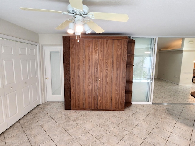 unfurnished bedroom featuring light tile patterned floors and ceiling fan