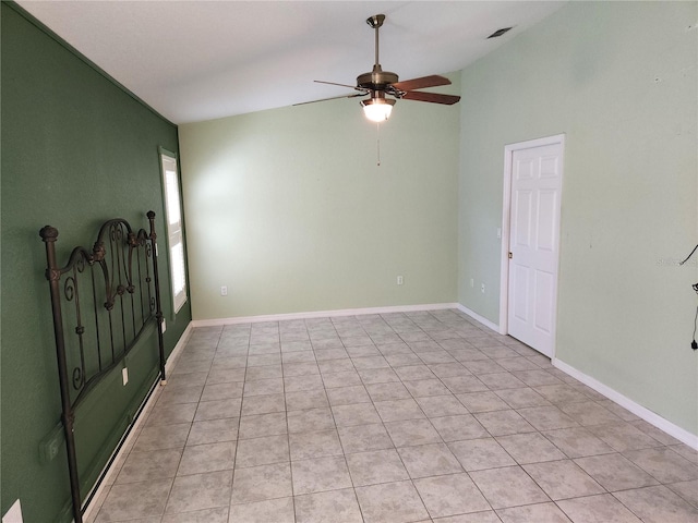 spare room with visible vents, baseboards, lofted ceiling, and a ceiling fan