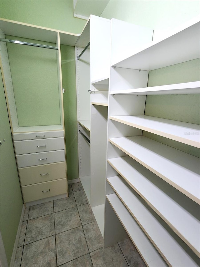 spacious closet featuring tile patterned flooring